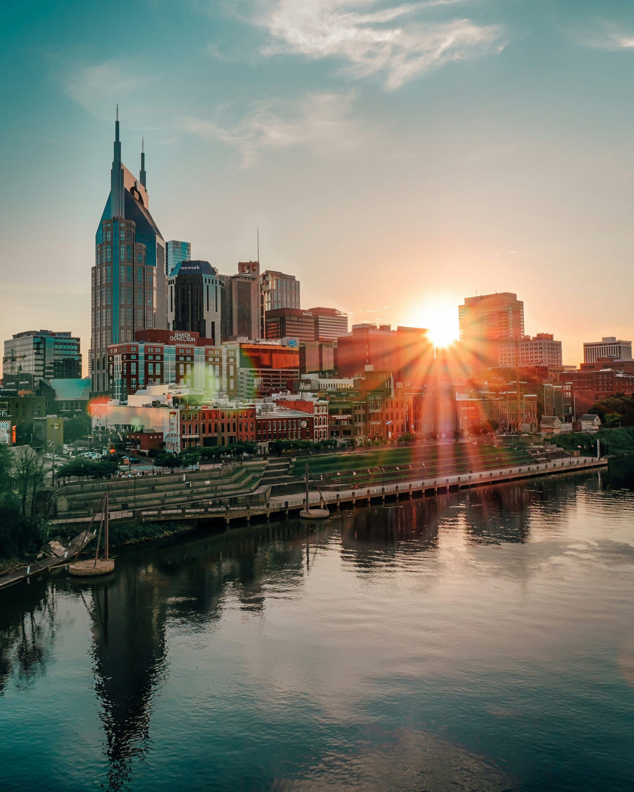 Nashville skyline and riverfront at sunset.